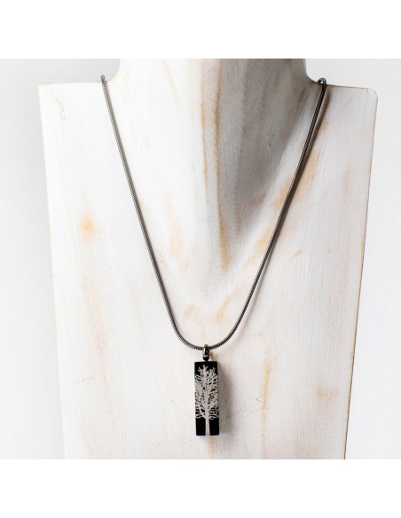Cremation keepsake pendant on a silver chain featuring a rectangular black graphite tree root charm.