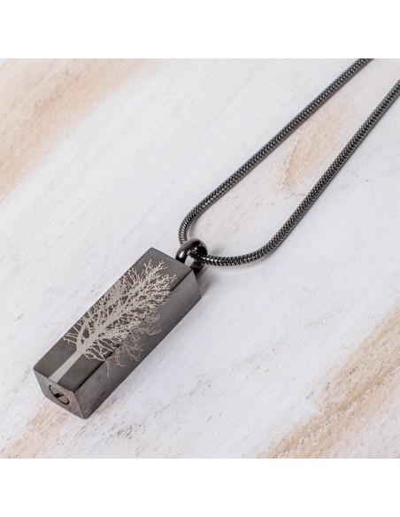 Cremation Jewell Tree Root Graphite Pendant on a silver chain, featuring an engraved tree design. Etternal funeral art.