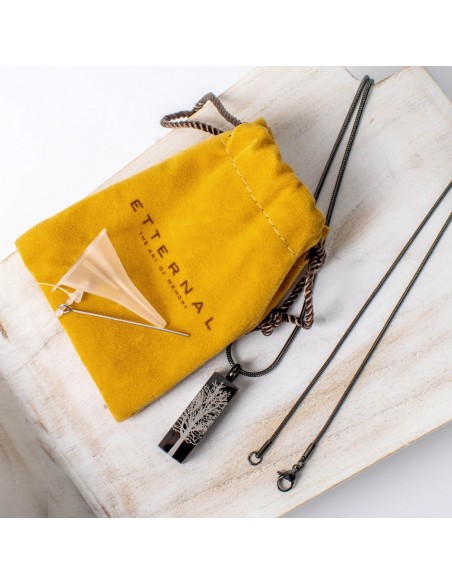 Cremation jewell tree root graphite pendant necklace with tree design, shown with yellow Etternal pouch and accompanying chain o