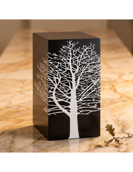 Graphite Tree RootT Cremation Urn by Etternal: black rectangular urn with a white, intricate tree silhouette on the front, place