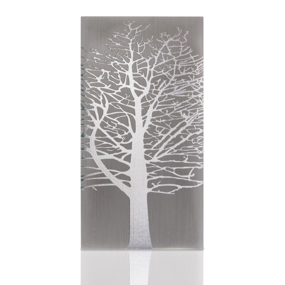 Cremation urn panel in brushed metal with a white leafless tree silhouette design, representing a tree root motif.