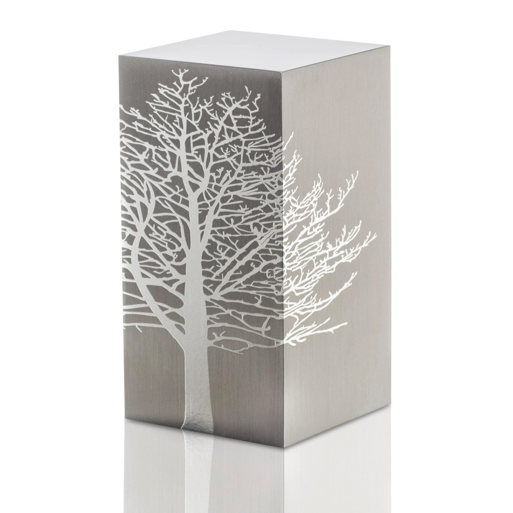 Cremation Urn Tree Root design by Etternal Arte Funerario in brushed silver with a white tree silhouette on the side.