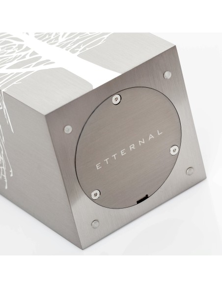 Cremation Urn Tree Root by Etternal Arte Funerario: brushed metal cube with round access plate labeled ETTERNAL on side, white t